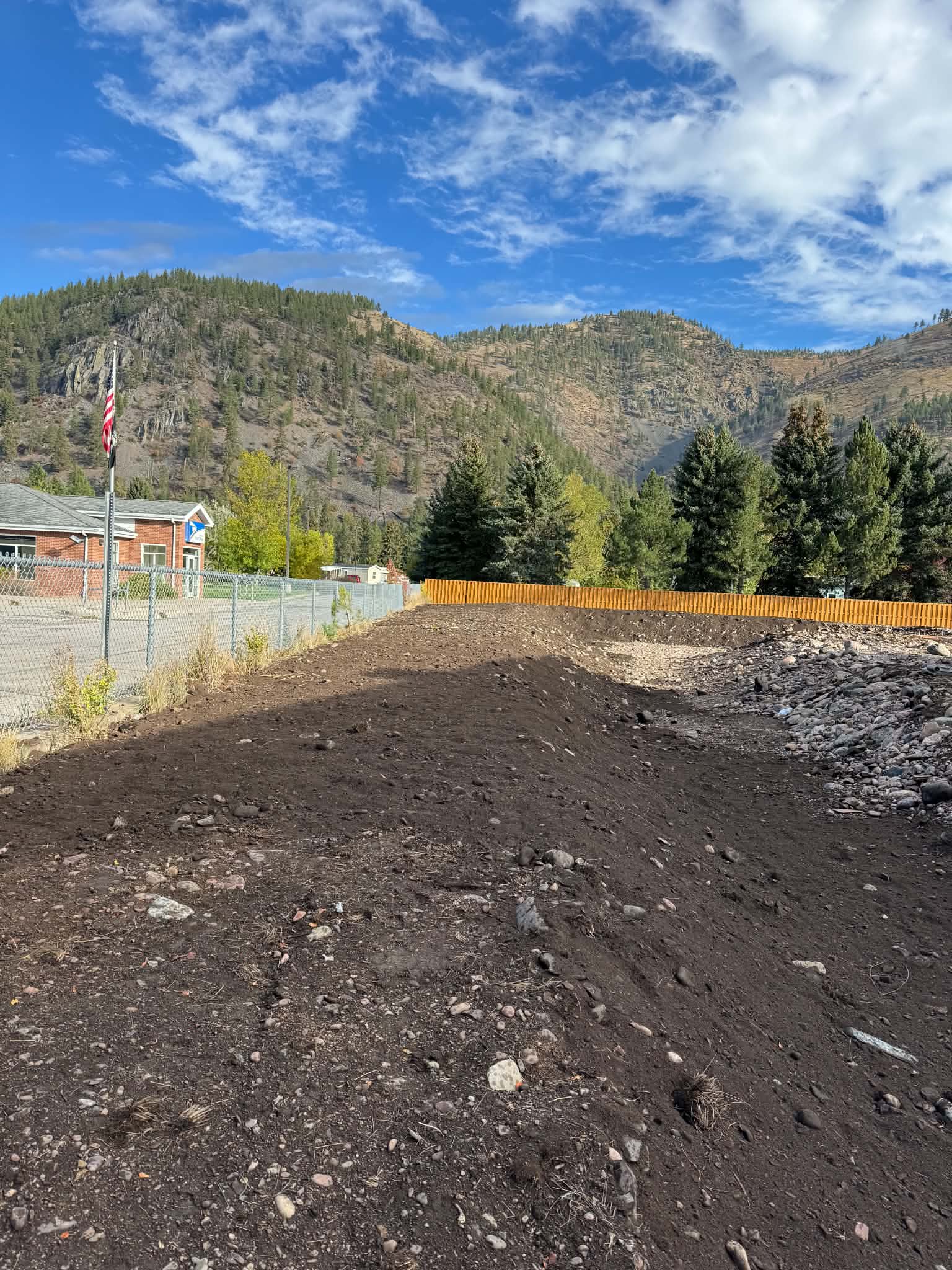 Cleared and graded site with mountains